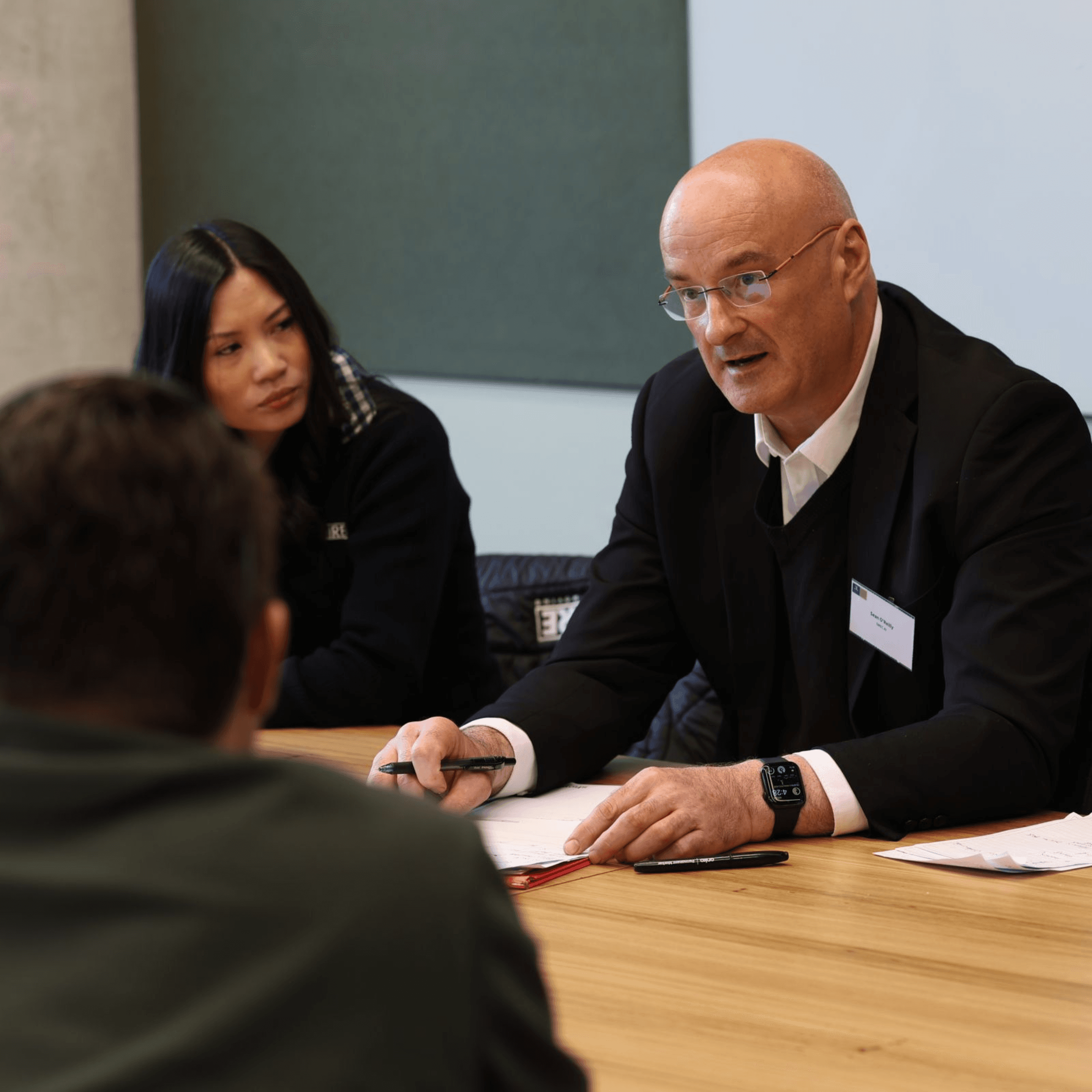 An Australian SME team reviewing AI tool recommendations on a laptop during a SMEC AI consultation